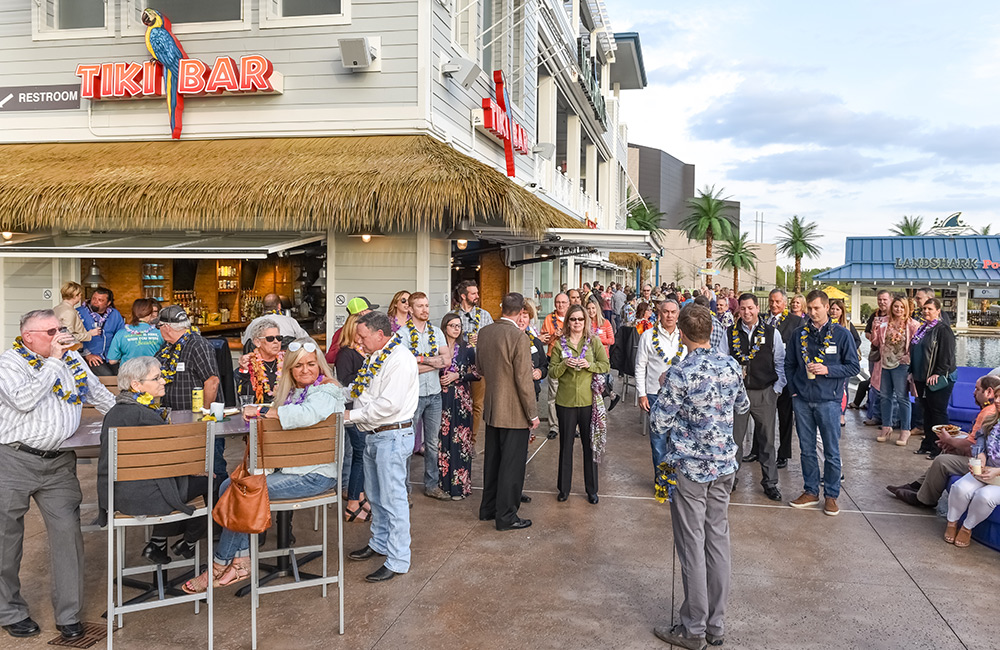 Group of people socializing outside the tiki bar